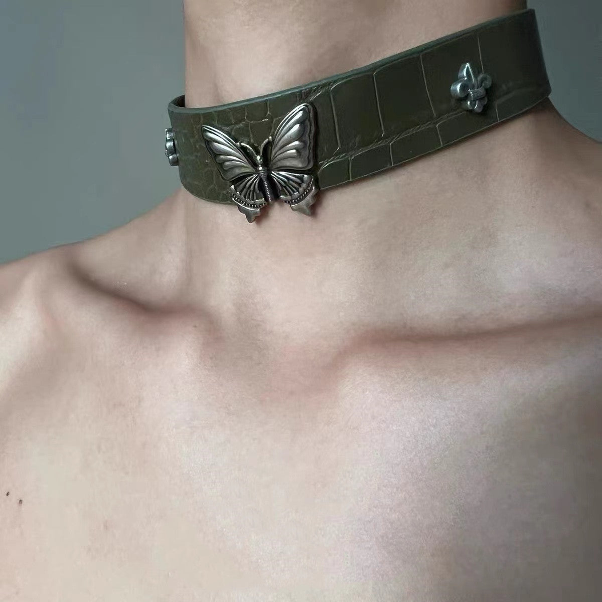 Dark green velvet choker with metallic butterfly accent